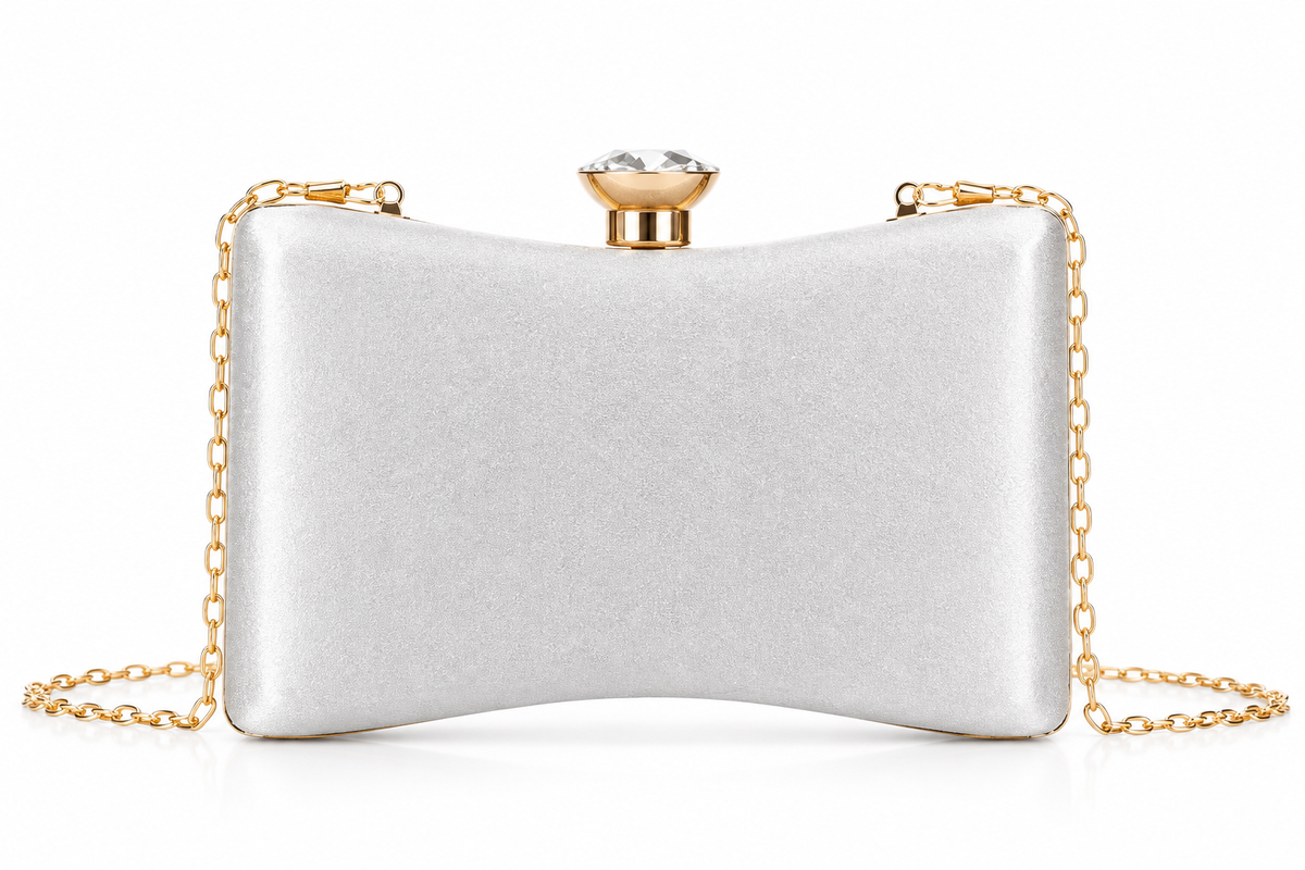 A silver satin clutch bag with a gold-tone chain strap and a rhinestone-embellished clasp, shown on a plain white background.