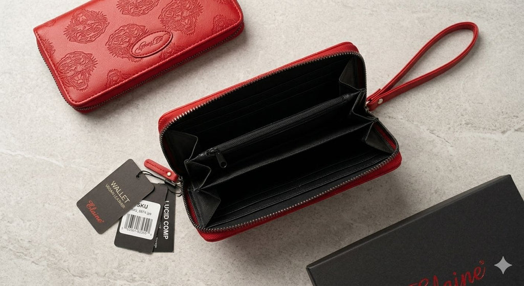 Red wallet with open design, tags, and box on a light gray surface